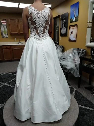 The back of a satin gown with a lace illusion bodice and buttons