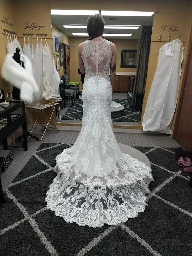 The back of a lace gown with a long scalloped lace train